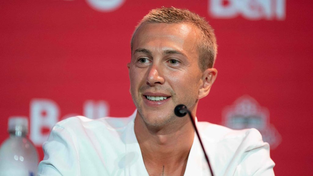 Soccer star Federico Bernardeschi at Toronto FC press conference red backdrop wallpaper