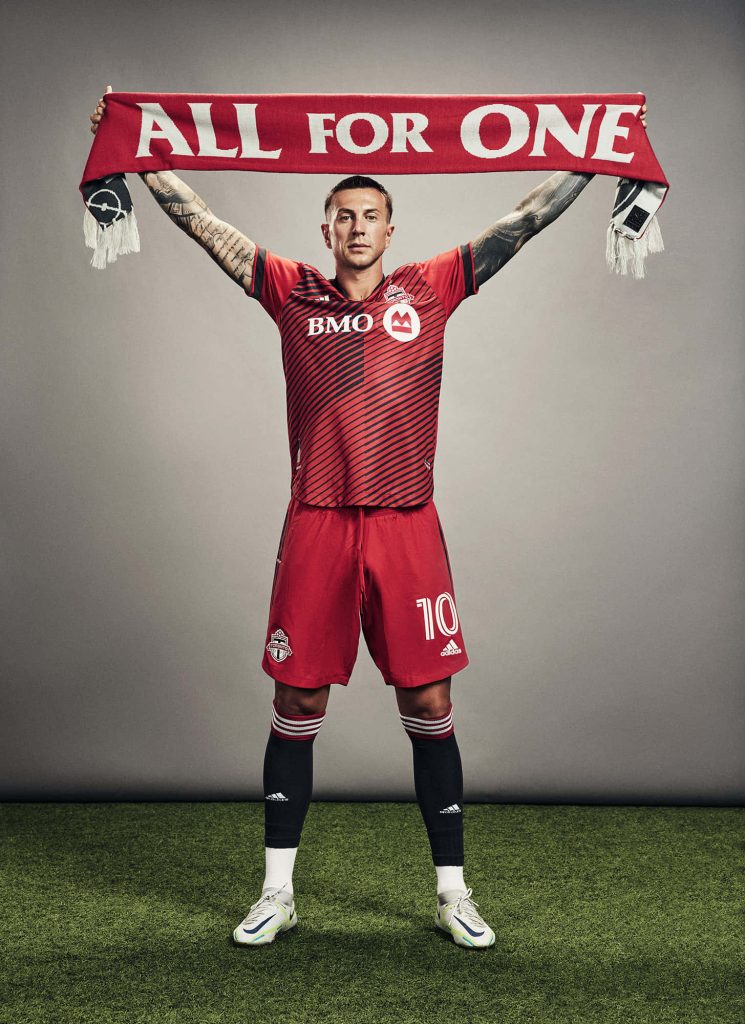 Federico Bernardeschi Toronto FC midfielder red kit holding All For One scarf wallpaper