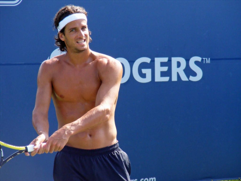 Shirtless tennis star Feliciano López holds Wilson racket with intense focus at Rogers Cup Wallpaper