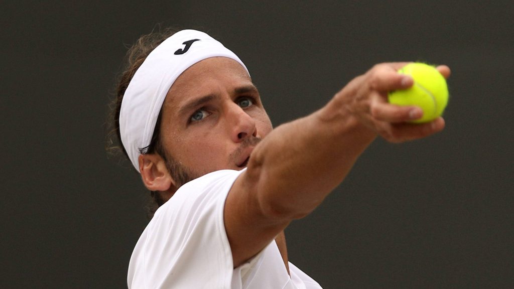 Feliciano López Wimbledon 2010 serve action in white Joma gear with focused expression wallpaper