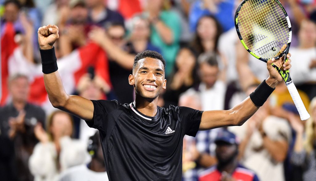 Tennis star Félix Auger-Aliassime celebrates victory with Babolat racket in black Adidas kit Wallpaper