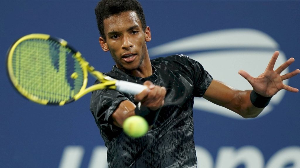 Felix Auger-Aliassime powerful forehand swing on US Open blue tennis court wallpaper background