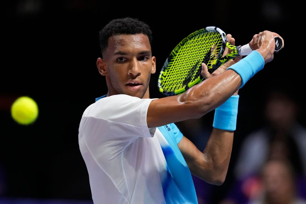 Felix Auger-Aliassime tennis action mid-swing with Babolat racquet intense focus wallpaper