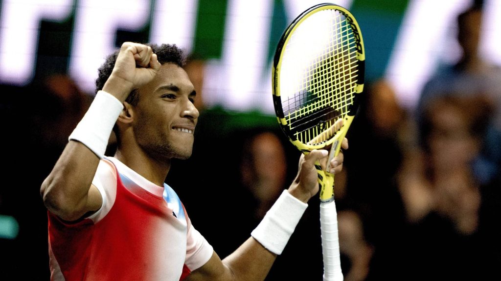 Félix Auger-Aliassime victorious tennis player smiling with fist pump and yellow racket wallpaper