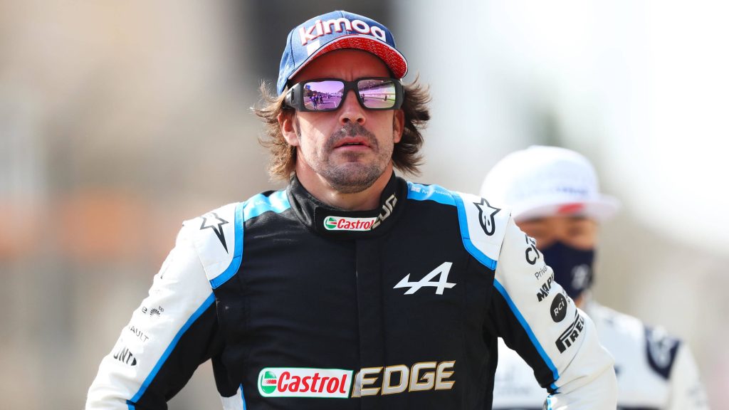 Fernando Alonso Alpine F1 driver in racing suit Kimoa cap reflective sunglasses intense portrait Wallpaper