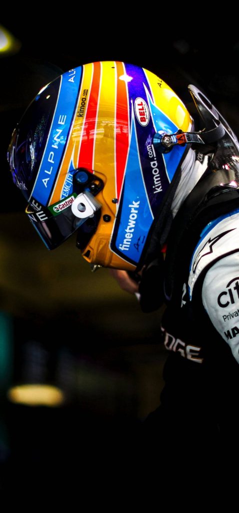 Fernando Alonso in Alpine F1 helmet blue yellow focused portrait dark background wallpaper