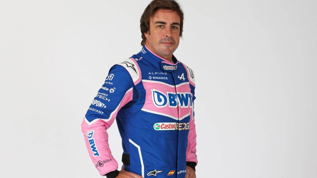 Fernando Alonso in vibrant pink blue BWT Alpine F1 Team racing suit studio portrait wallpaper