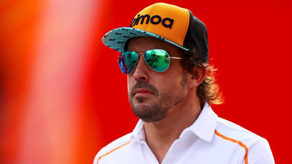 Fernando Alonso F1 legend portrait red background Kimoa cap aviator sunglasses white polo wallpaper