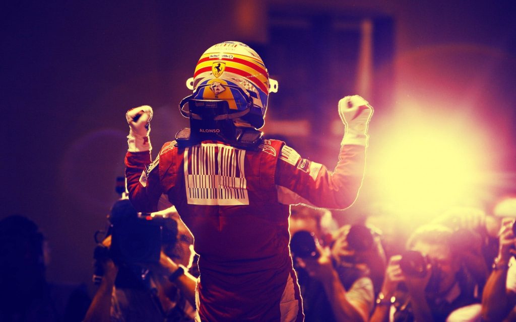 Fernando Alonso Ferrari racing suit raising arms victory F1 race photographers wallpaper background