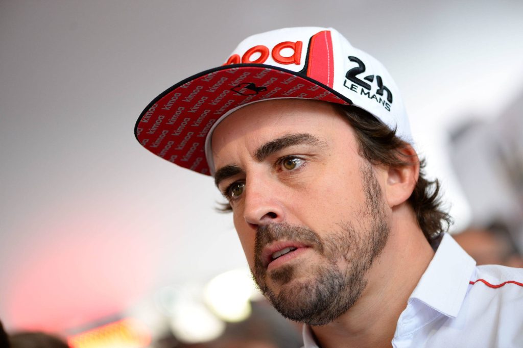 Close-up portrait of racing champion Fernando Alonso wearing 24h Le Mans and Kimoa cap Wallpaper
