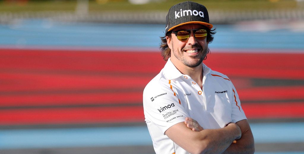 Fernando Alonso confident smile in McLaren polo and Kimoa cap at race track high-definition wallpaper