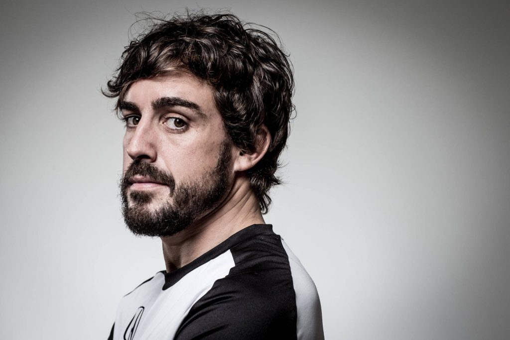 Professional studio portrait of Formula 1 champion Fernando Alonso in black and white shirt Wallpaper