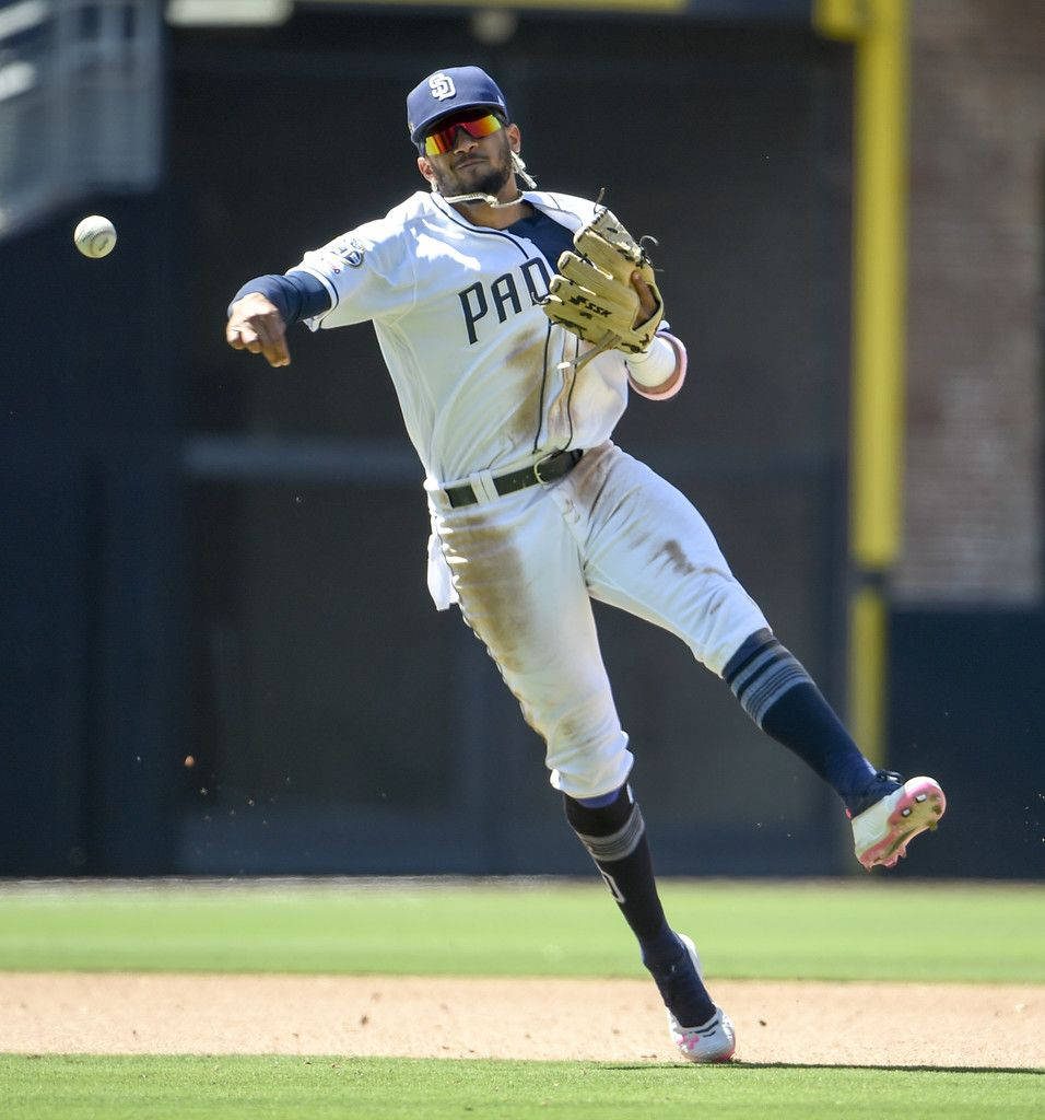 San Diego Padres Fernando Tatís Jr. throwing a baseball in action wearing home uniform wallpaper