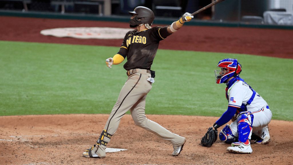 Fernando Tatis Jr. swinging at home plate against Texas Rangers catcher MLB action wallpaper
