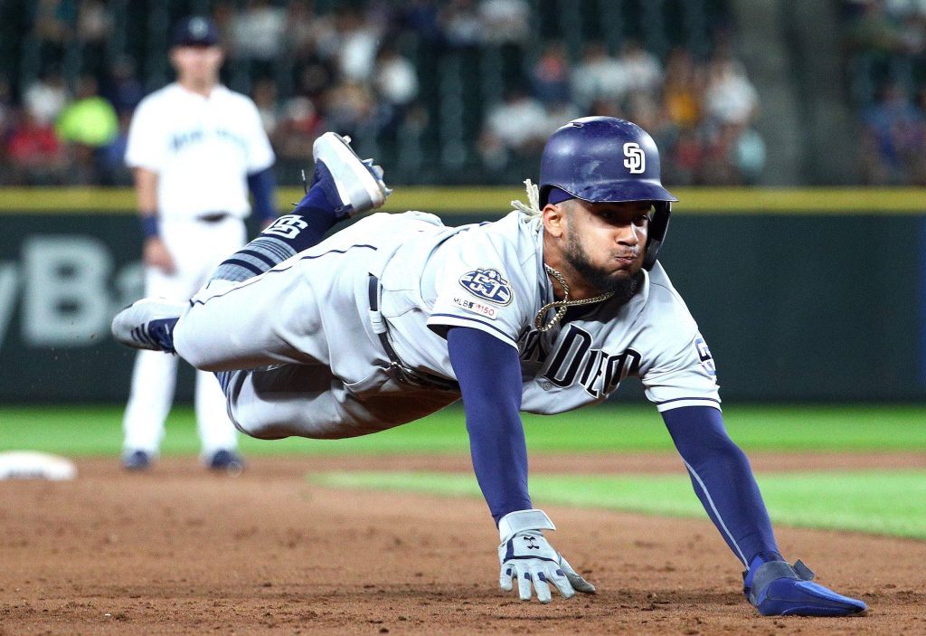 Fernando Tatís Jr. diving into base in Padres gray uniform MLB night game wallpaper background