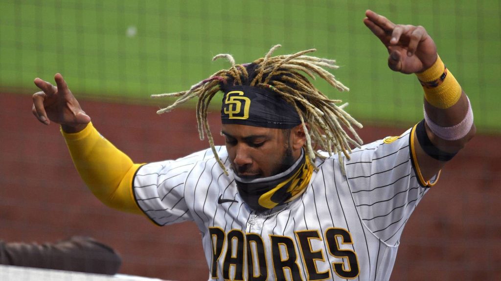 Fernando Tatis Jr. San Diego Padres mid-celebration in pinstripe jersey and blonde dreadlocks wallpaper