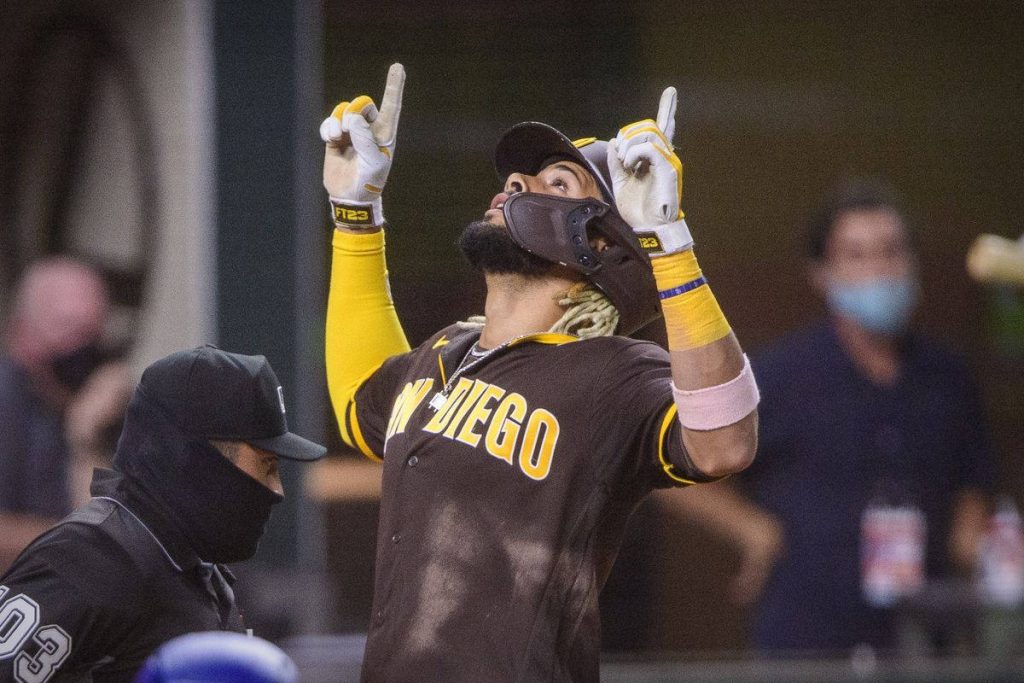 Fernando Tatís Jr. Padres celebrating in brown gold jersey dynamic MLB action wallpaper