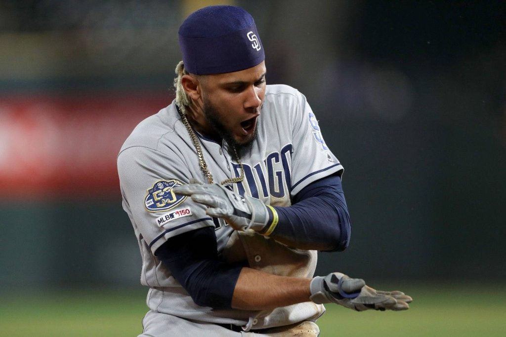 Fernando Tatís Jr in San Diego Padres road jersey celebrating MLB 150 with stadium background Wallpaper