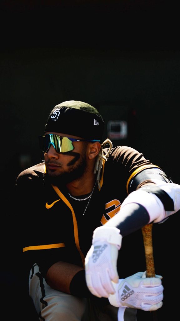 Fernando Tatís Jr in San Diego Padres uniform crouching with bat sunglasses Adidas gloves wallpaper
