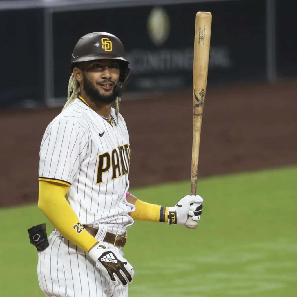 Fernando Tatís Jr. in Padres white pinstripe jersey swinging bat vibrant MLB action wallpaper