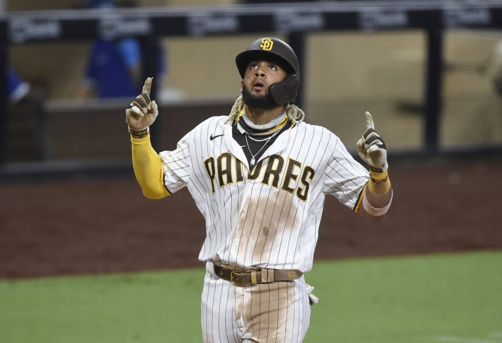 Fernando Tatís Jr Padres celebrating in pinstriped uniform high quality baseball wallpaper background
