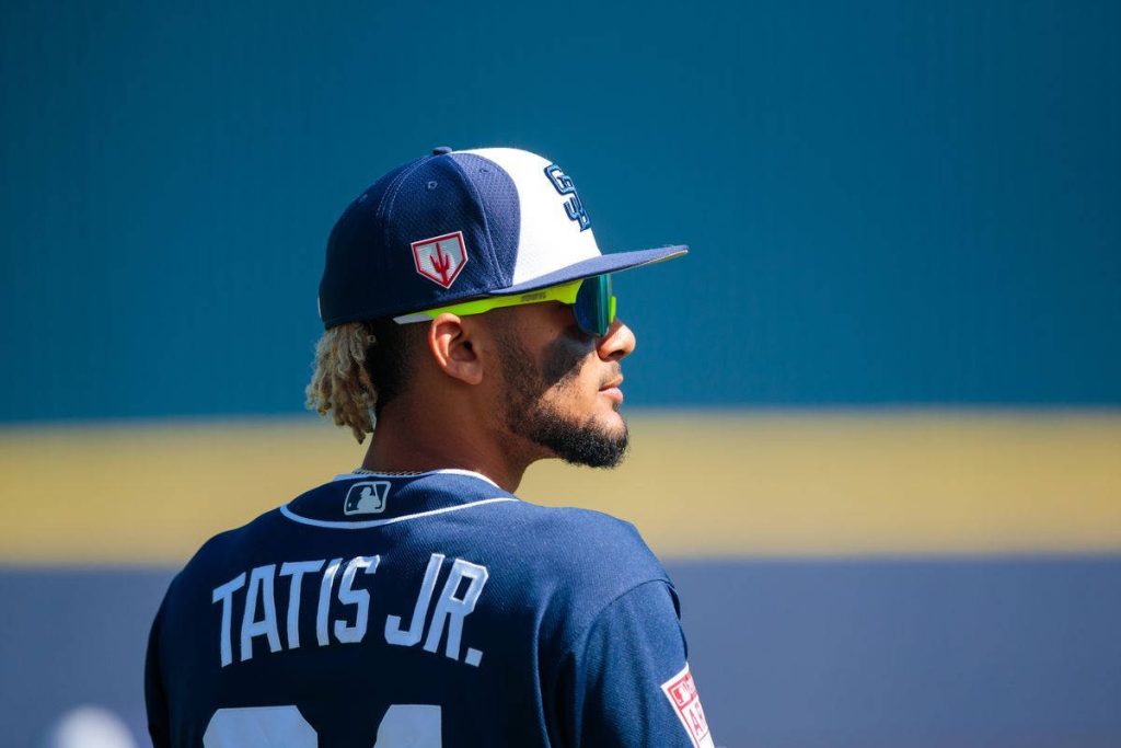 Fernando Tatís Jr in navy Padres uniform and sunglasses vibrant blue MLB baseball wallpaper background