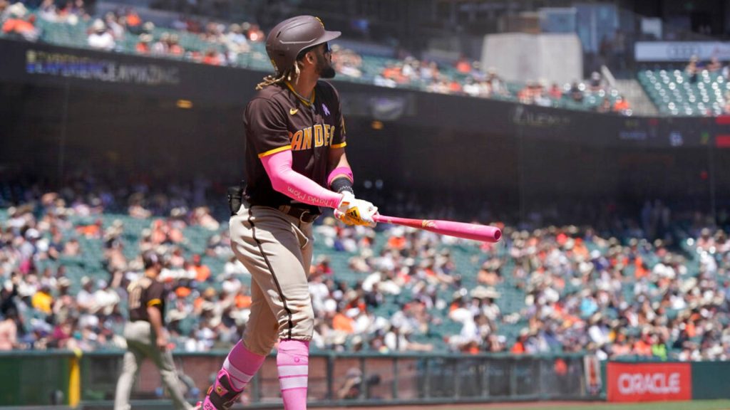 Fernando Tatís Jr. batting in Padres uniform with pink gear vibrant sports wallpaper background