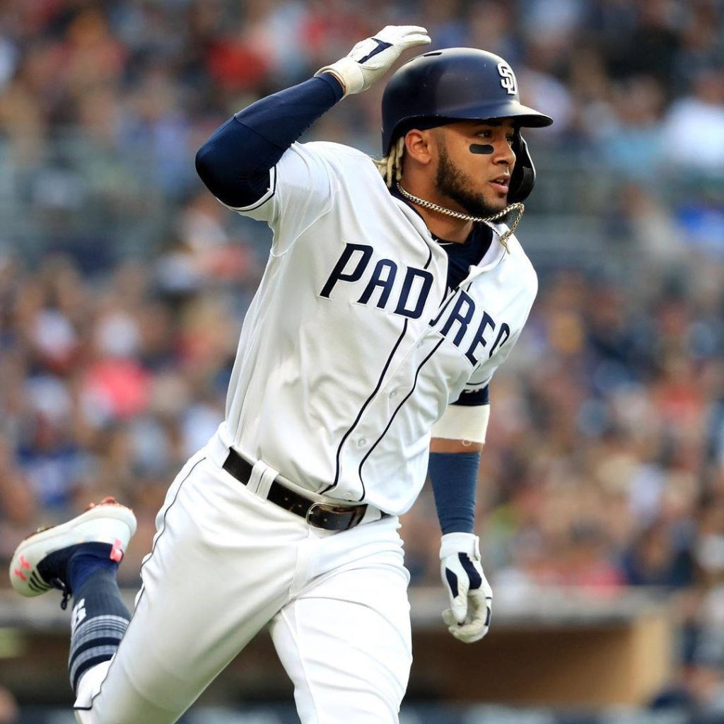 Fernando Tatís Jr. running in San Diego Padres uniform vibrant baseball stadium background wallpaper