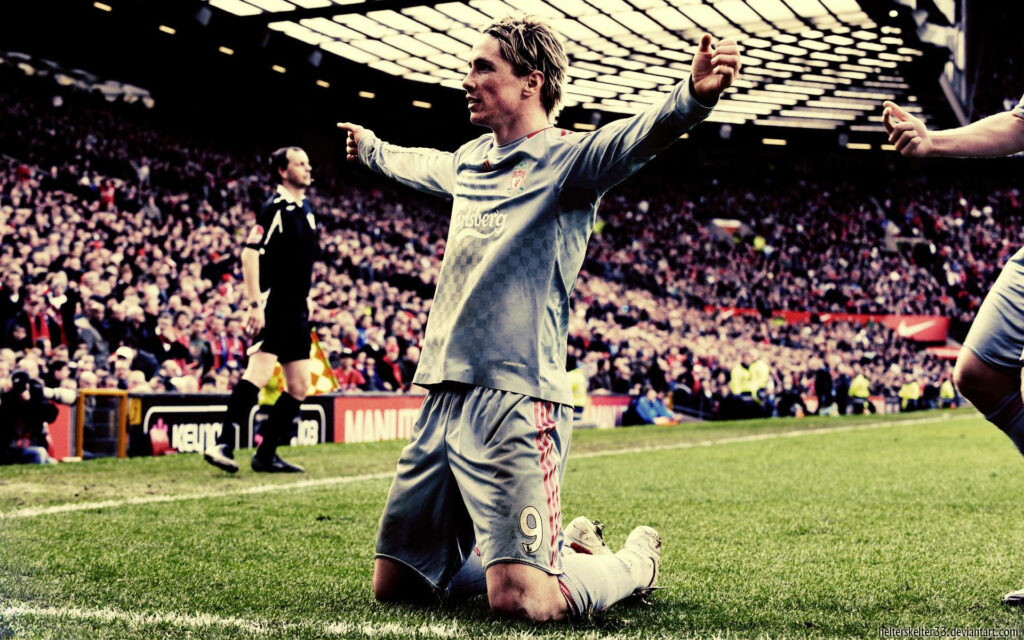 Fernando Torres celebrates football goal kneeling on field arms outstretched iconic moment wallpaper