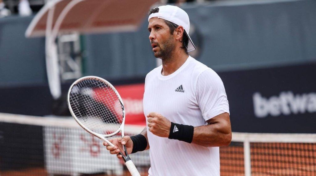 Fernando Verdasco focused in white Adidas tennis kit on clay court intense match wallpaper