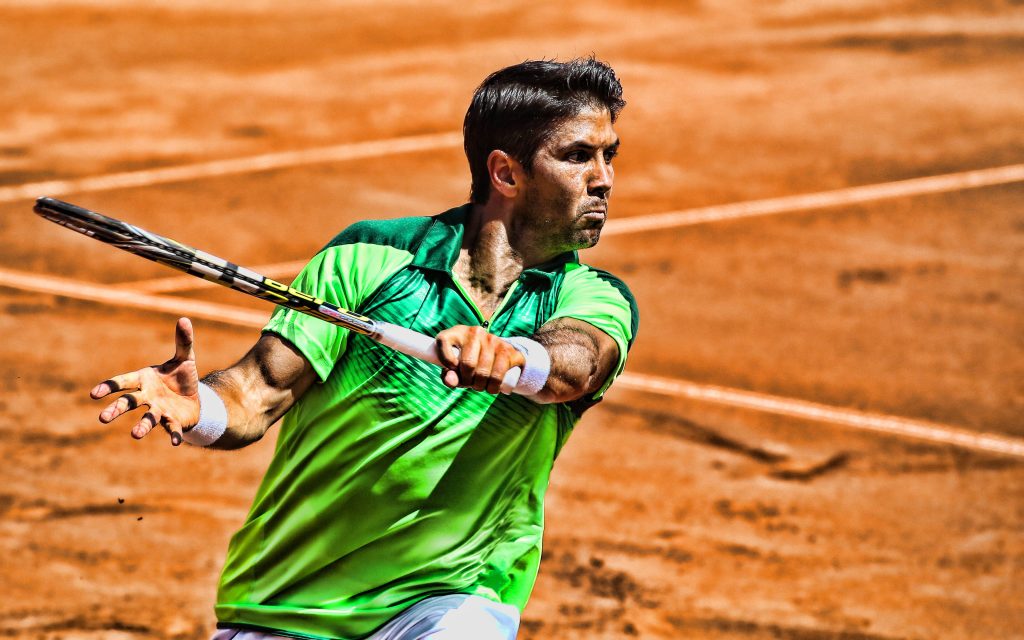 Fernando Verdasco powerful forehand on red clay court vibrant lime green shirt tennis action Wallpaper
