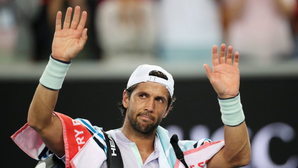 Fernando Verdasco tennis player raising hands wearing white cap intense sports wallpaper background