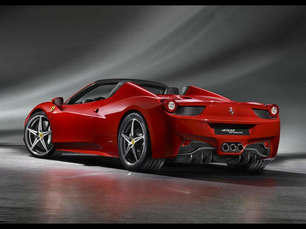 Ferrari 458 Spider in vibrant red with sleek design on dramatic studio backdrop wallpaper