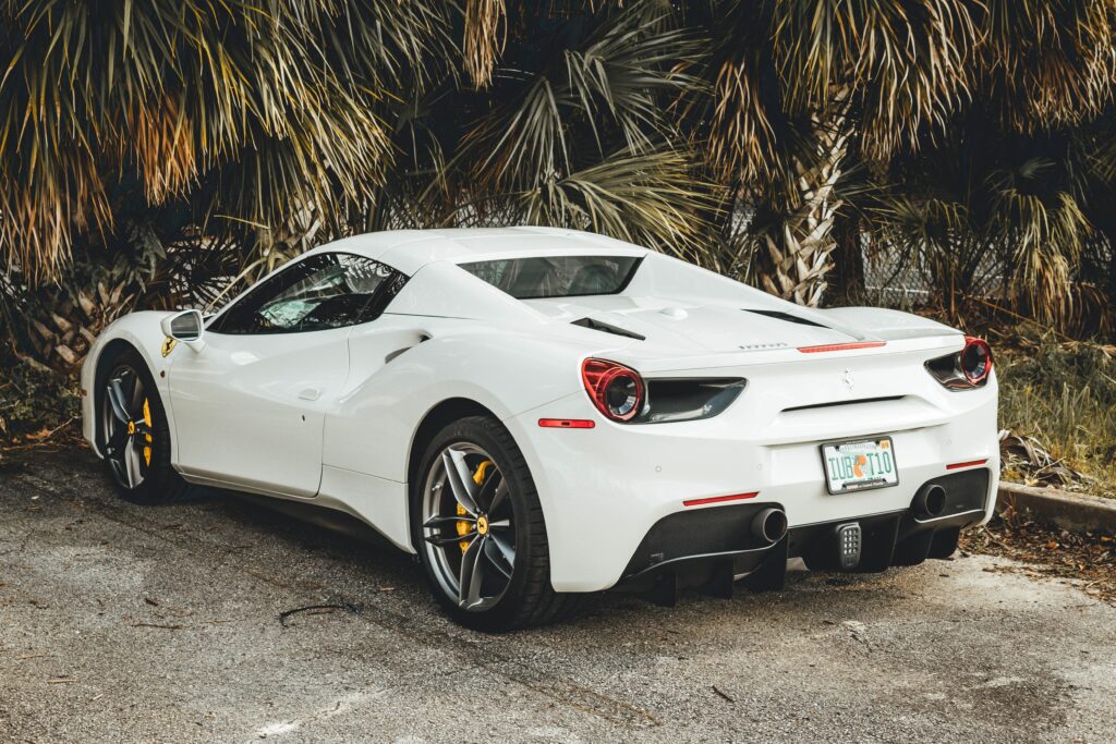 Ferrari 488 GTB Wallpaper: Luxury Sports Car Amid Tropical Foliage