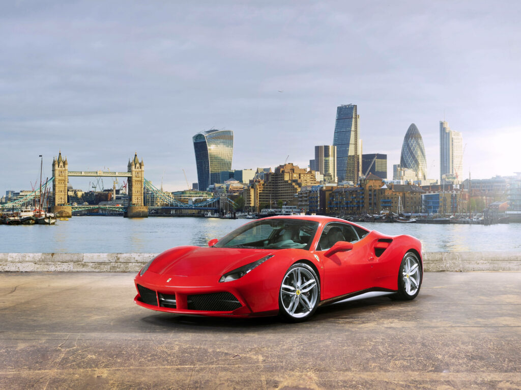 Cruising the Urban Jungle: A Spectacular Cityscape Backdrop for the Iconic Red Ferrari 488 Wallpaper
