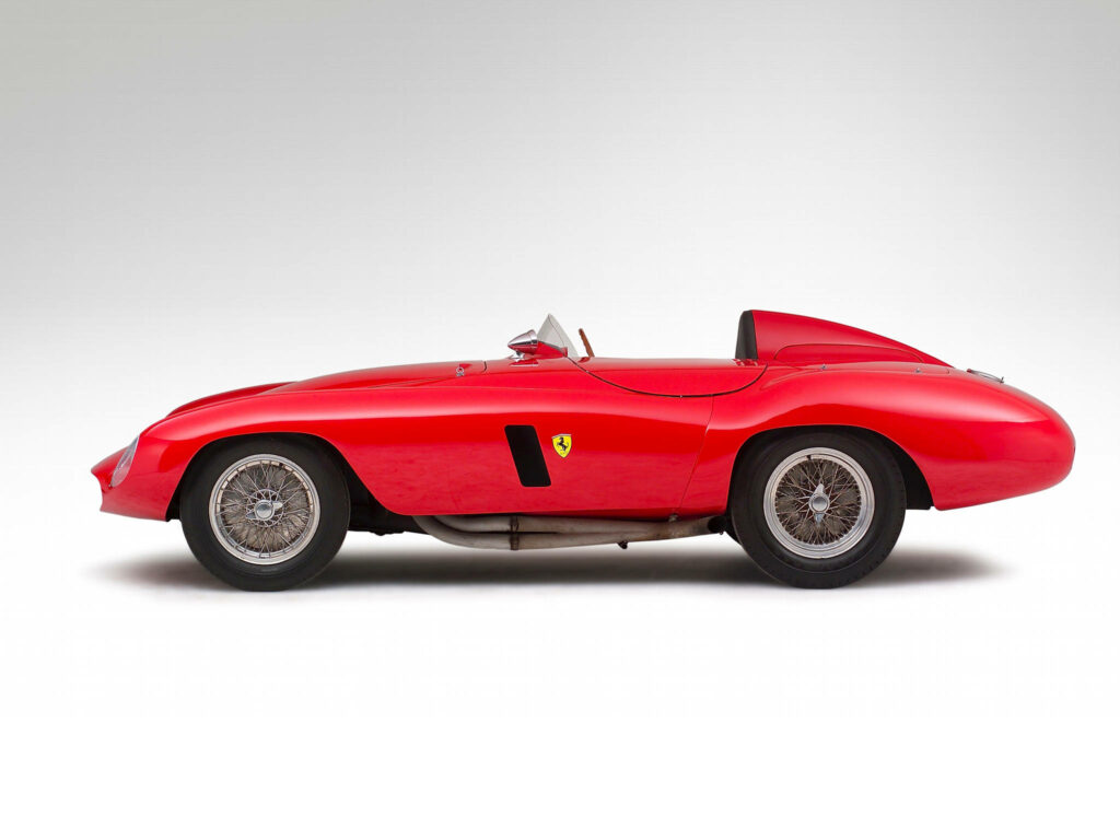 Sleek and Captivating: Immersed in the Vibrant World of a Classic Red 1954 Ferrari 750 Monza Racing Car Wallpaper