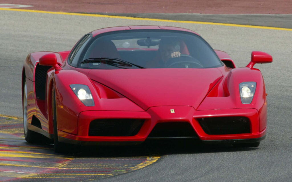 The Exquisite Ferrari Enzo: Dazzling Red Elegance Embodied in a 1680x1050 HD Wallpaper
