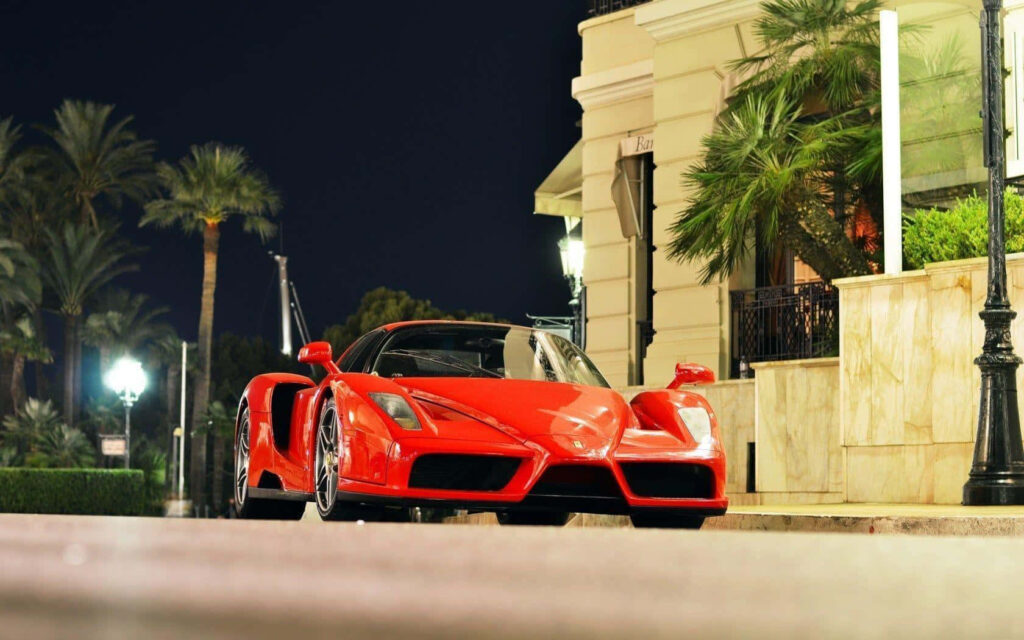 Exhilarating Capture: Ferrari Enzo Zooms on Serene Path, Unleashing Power and Exquisite Style Wallpaper