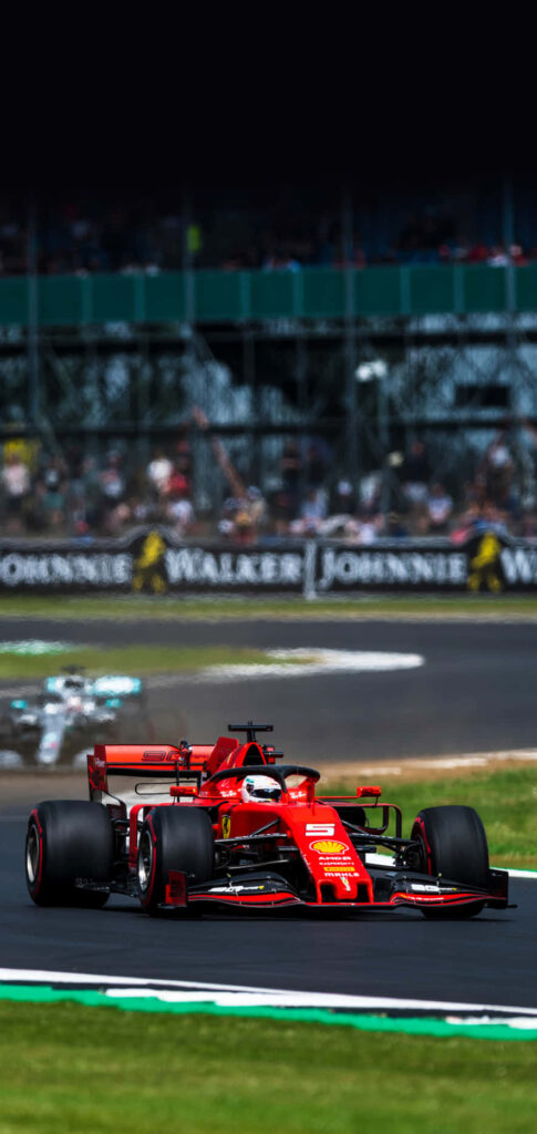 Unleashing the Ferocious Fury: A Dynamic Snapshot of the Iconic Ferrari F1 Car, Primed for Track Domination! Wallpaper