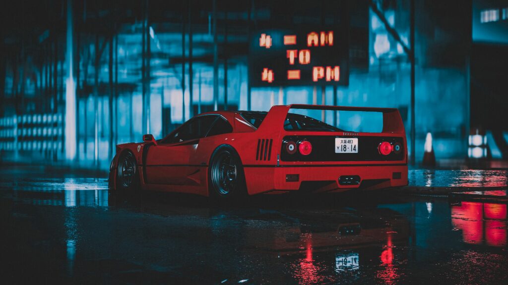 Ferrari F40 Wallpaper: Stunning Red Sports Car with Neon Reflections