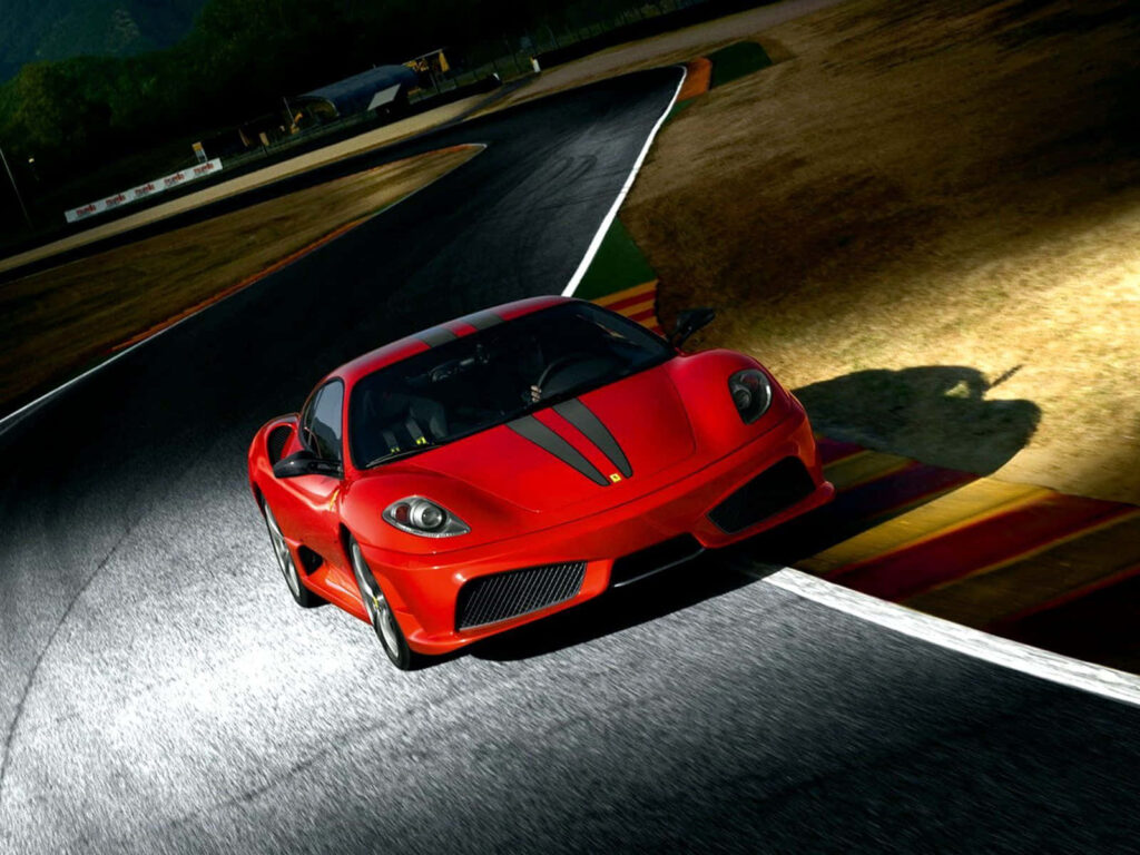 Exhilarating Drive: The Dynamic Ferrari F430 Roams a Breathtaking Landscape Wallpaper