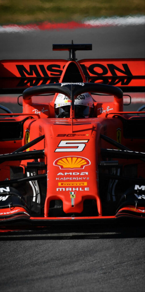 Close-up of vibrant red Ferrari Formula 1 car with Mission Winnow branding on racing track Wallpaper