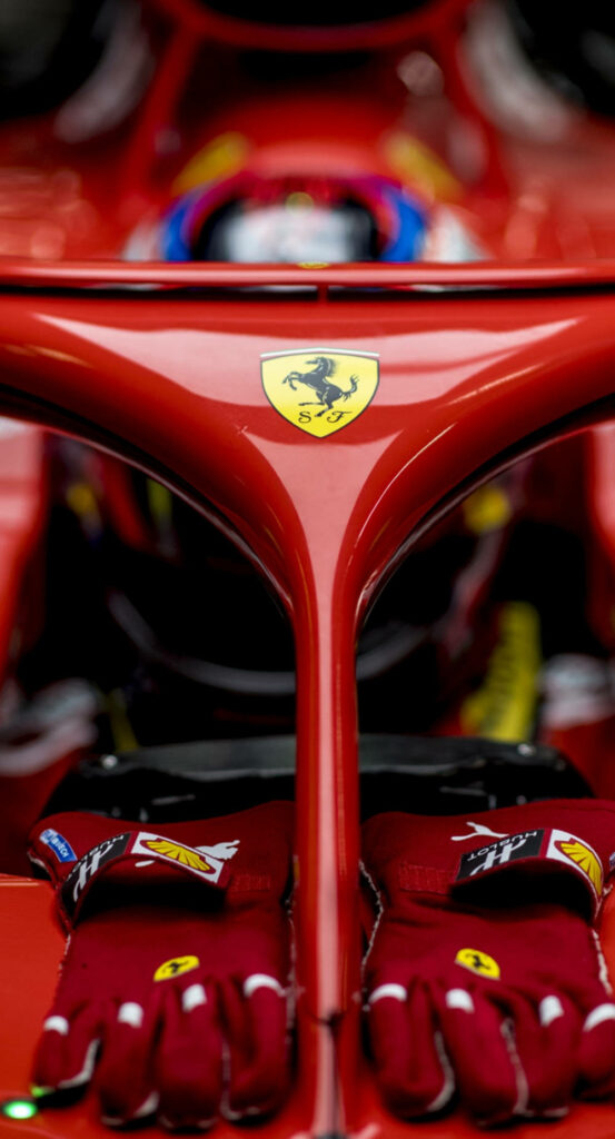 Close-up of Ferrari Formula 1 cockpit with Prancing Horse logo and Ferrari racing gloves wallpaper