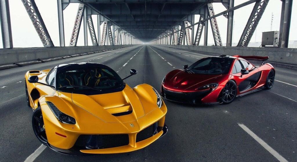 Cruising with Unmatched Power: A Captivating High-Resolution Shot of a Red Ferrari LaFerrari, Displaying its Sleek Design on the Road. Wallpaper