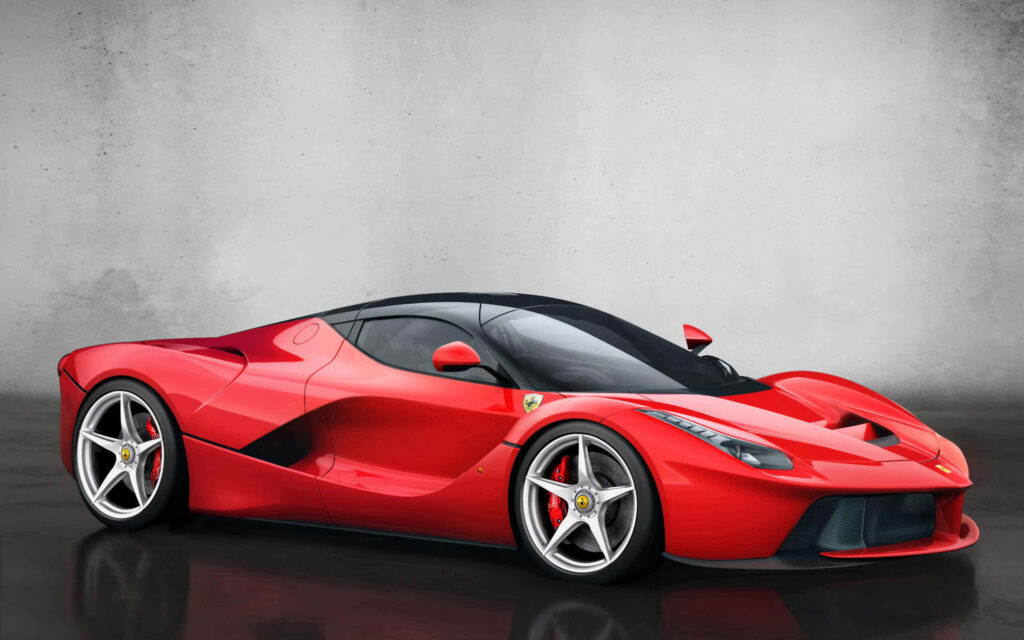 Red Ferrari LaFerrari against a Grey Wall Background Wallpaper