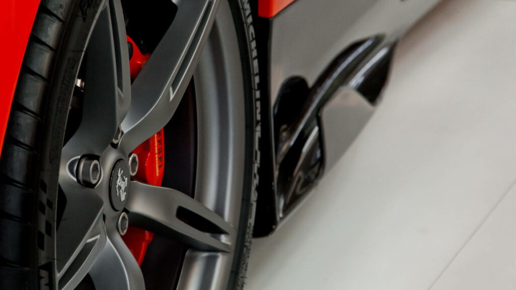 Ferrari's Fiery Wheels: Intense Black & Red Close-up for a Striking Wallpaper and Background Picture