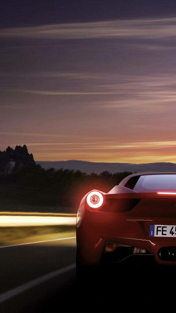 Ravishing Sunset Silhouette: Captivating Rearview Snapshot of Glowing Ferrari with Violet Horizon Wallpaper