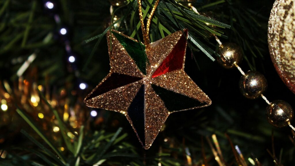 Sparkling Golden Star Ornament: Festive New Year Wallpaper Background