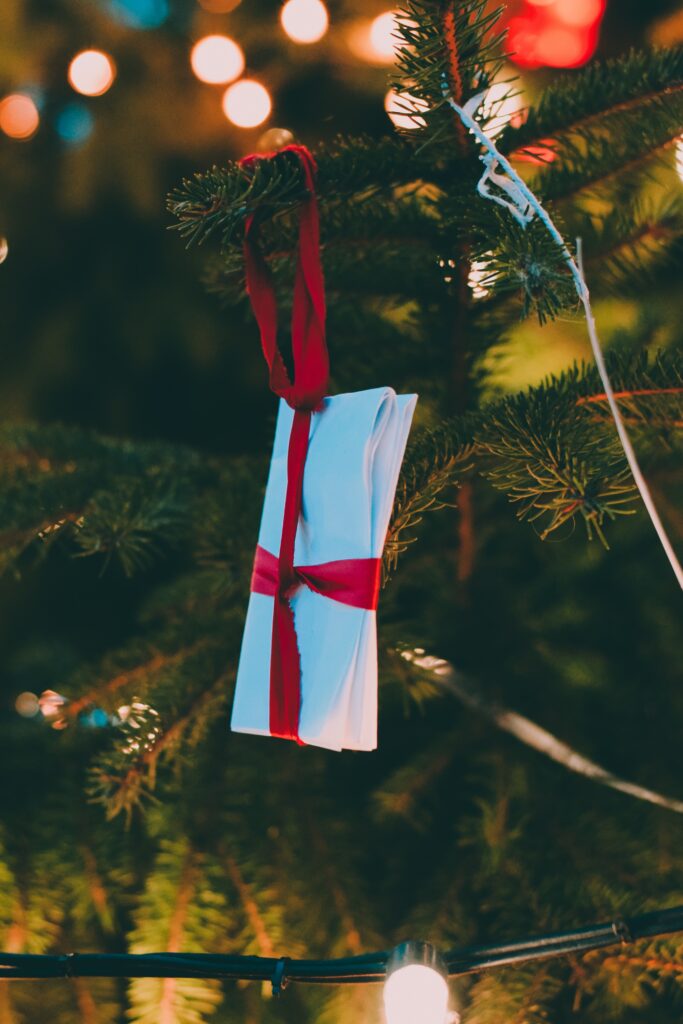 Festive Tree Branch Wallpaper: Cheerful Ornament & Glowing Lights