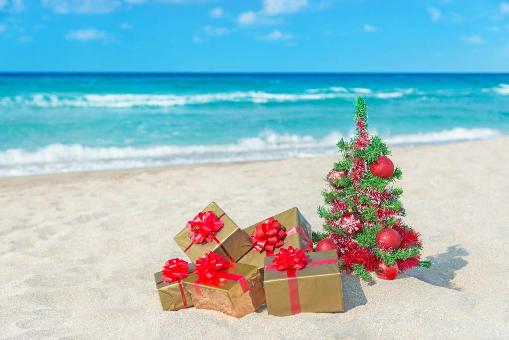 Festive Australian Beach Christmas with Gifts & Decorated Tree Wallpaper